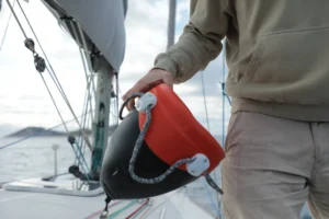 The sailor holding the anchor smart buoy | Boat Anchoring Setup
