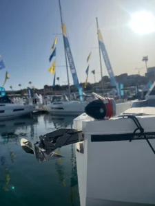 A red and black Knox anchor buoy mounted on the deck of a white sailboat - image used for the blog - How to choose the best anchor for your boat